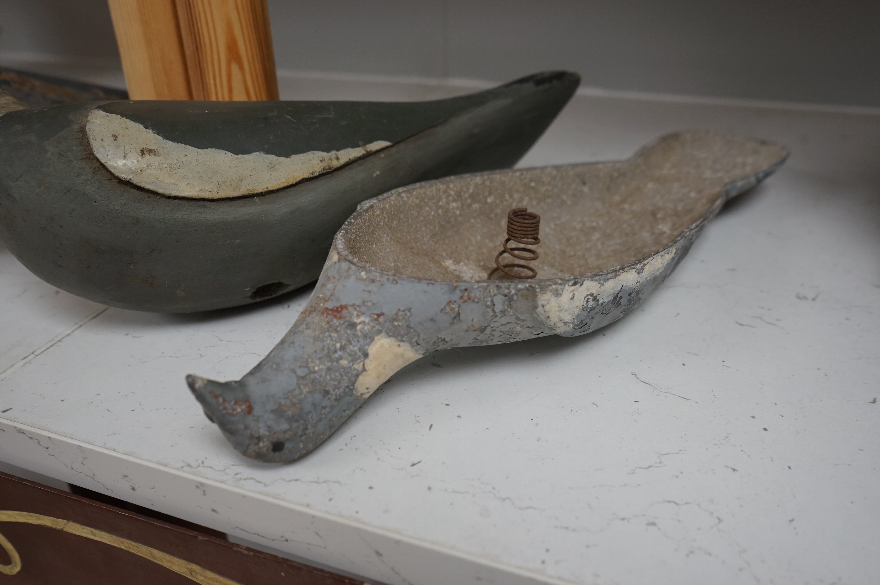 Three early 20th century carved wood decoy pigeons and a later cast metal decoy. Largest 35cm long. Condition - variable